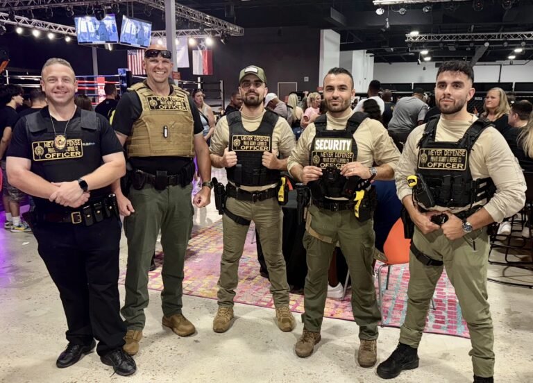 Security officers from Mayer Security Services posing at an event, showcasing their uniforms and equipment, emphasizing professional security presence.